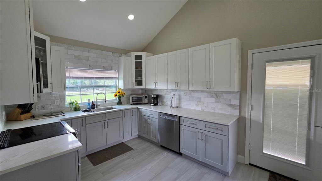 13330 Fort King Road Dade City, FL 33525 - Photo 16 of 43 a kitchen with a sink cabinets and window