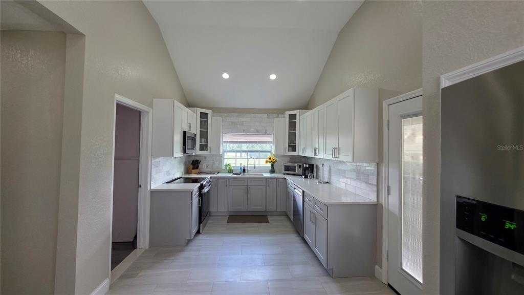 13330 Fort King Road Dade City, FL 33525 - Photo 18 of 43 a kitchen with a sink a counter top space stainless steel appliances and cabinets