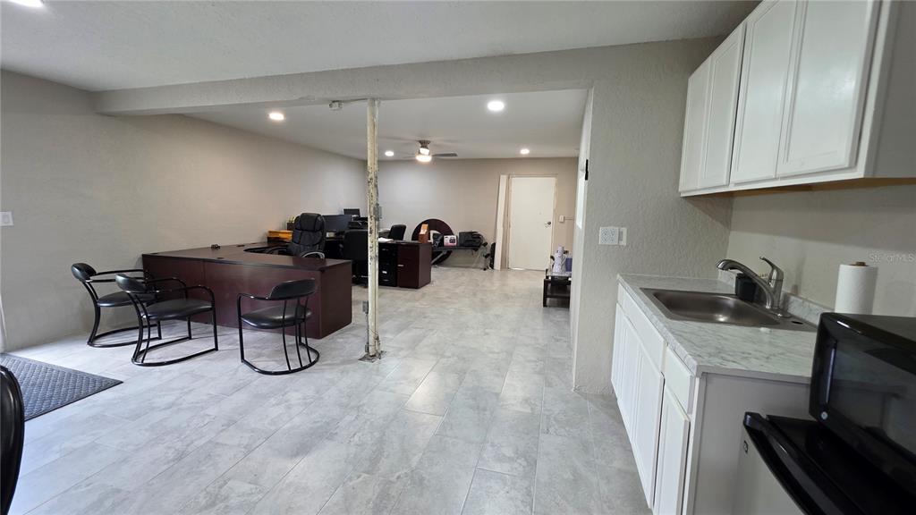 13330 Fort King Road Dade City, FL 33525 - Photo 35 of 43 a kitchen with sink cabinets and stove top oven