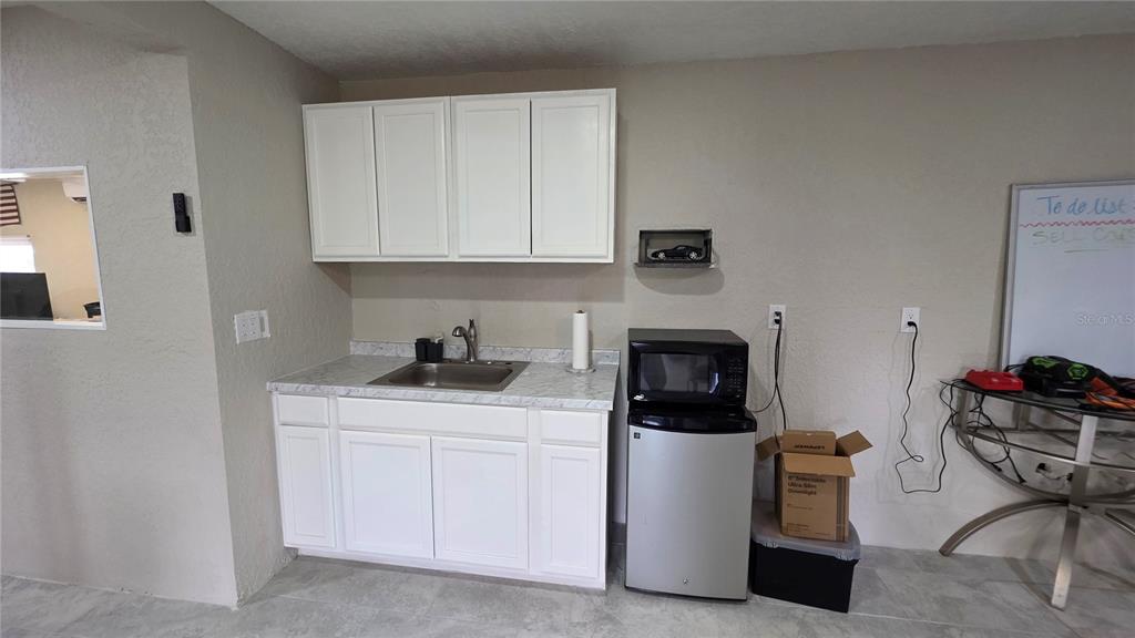 13330 Fort King Road Dade City, FL 33525 - Photo 36 of 43 a kitchen with a white cabinets and fireplace
