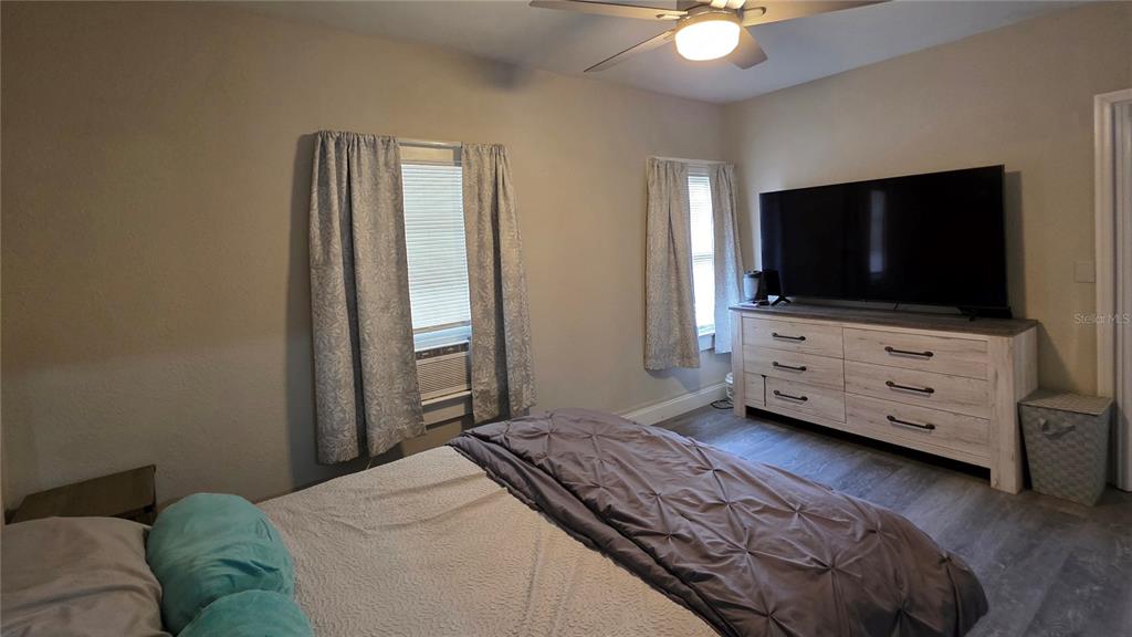 13330 Fort King Road Dade City, FL 33525 - Photo 9 of 43 a bedroom with a bed and a flat screen tv