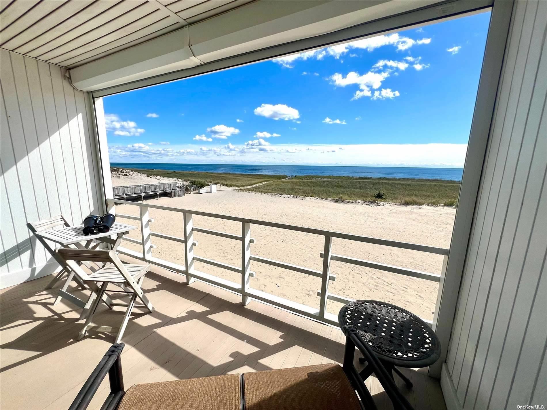459 Dune Road, Unit 7B Westhampton Beach, NY 11978 - Photo 1 of 1 a view of a livingroom with furniture window and outside view