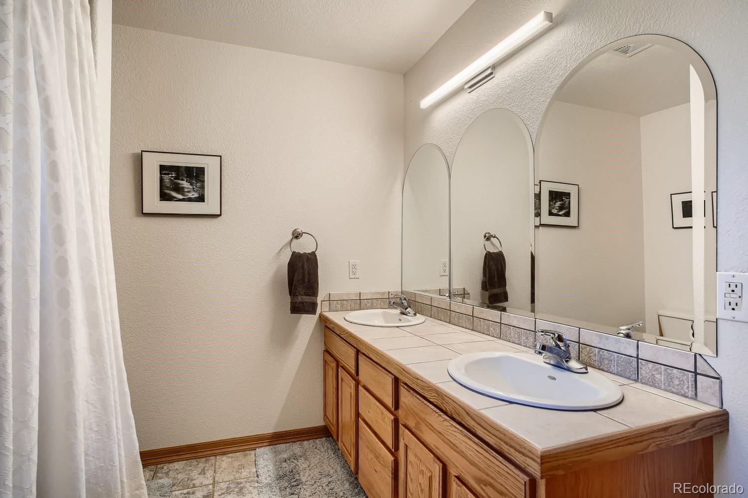 731 Hitchrack Road Bailey, CO 80421 - Photo 15 of 22 a bathroom with a sink and a mirror