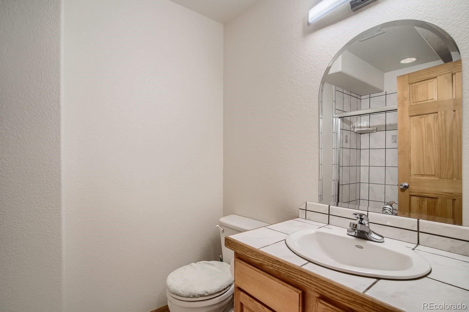 731 Hitchrack Road Bailey, CO 80421 - Photo 17 of 22 a bathroom with a sink a toilet and mirror