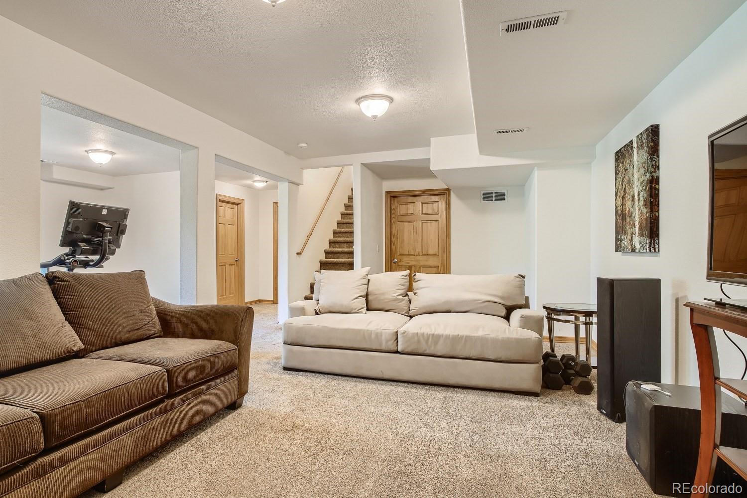 731 Hitchrack Road Bailey, CO 80421 - Photo 20 of 22 a living room with furniture and a flat screen tv
