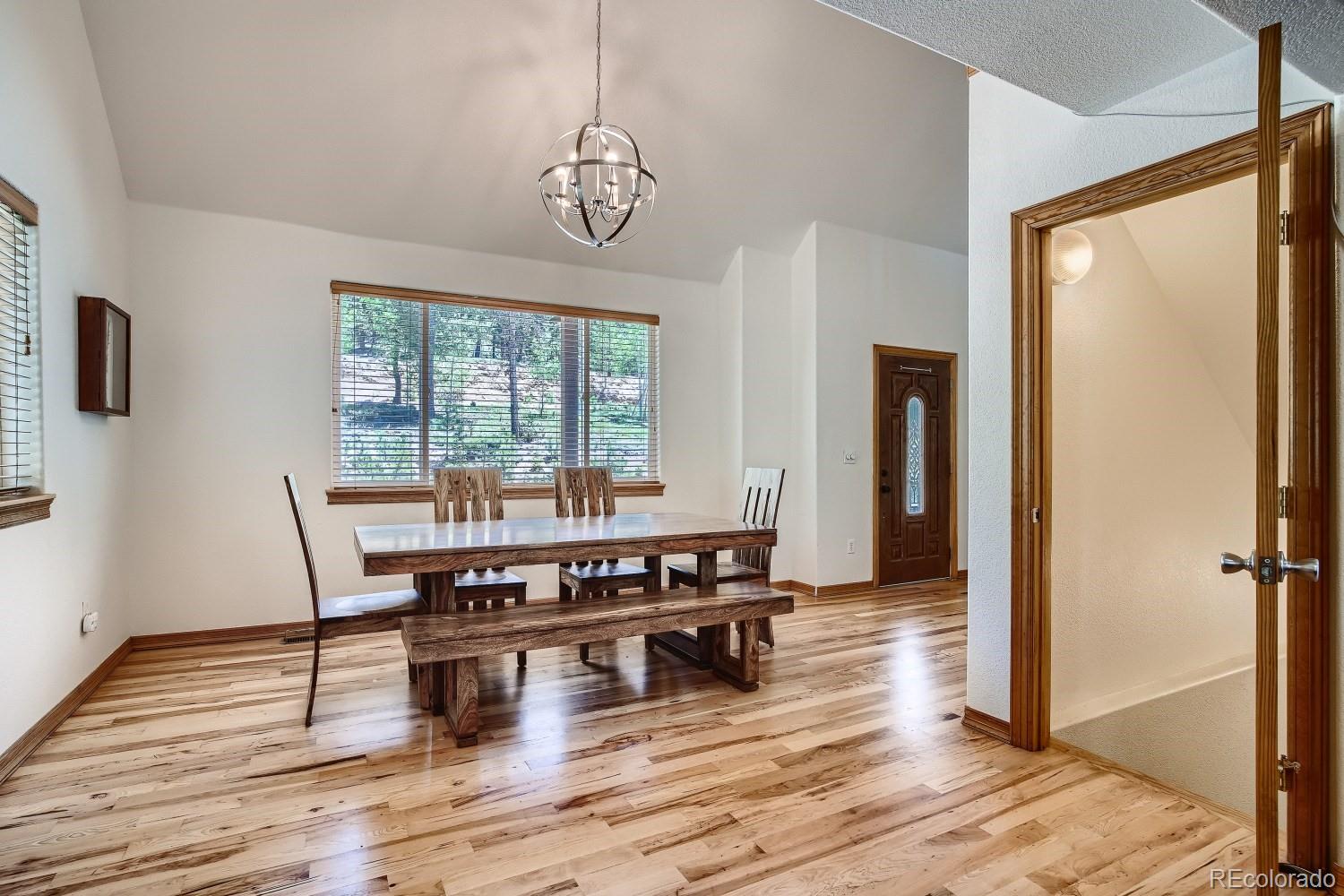 731 Hitchrack Road Bailey, CO 80421 - Photo 4 of 22 a view of a dining room with furniture window and wooden floor