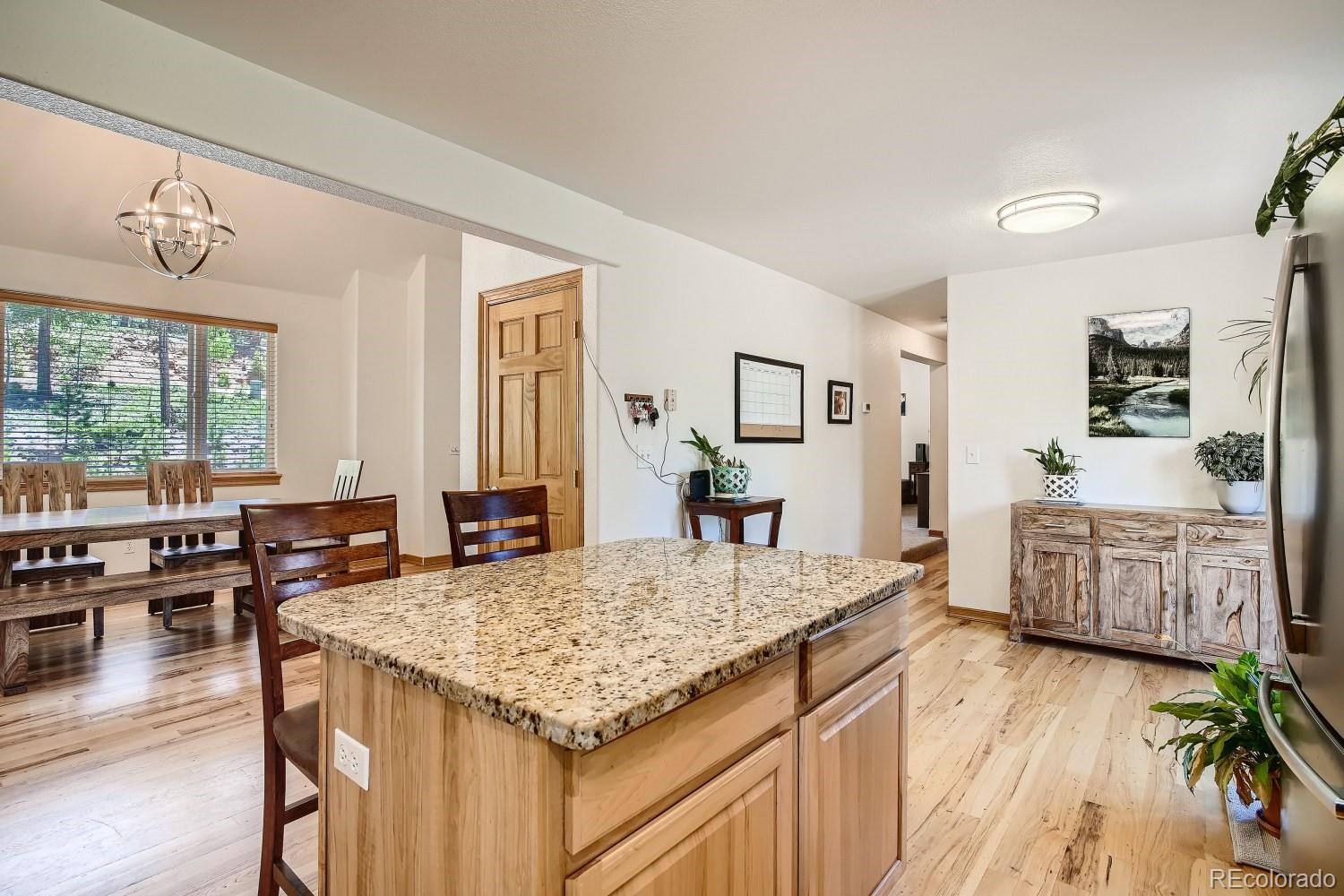 731 Hitchrack Road Bailey, CO 80421 - Photo 6 of 22 a kitchen with granite countertop a stove and a table