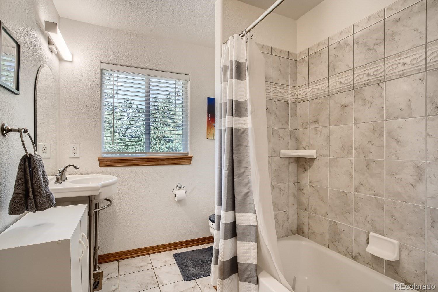 731 Hitchrack Road Bailey, CO 80421 - Photo 9 of 22 a bathroom with a sink toilet and shower