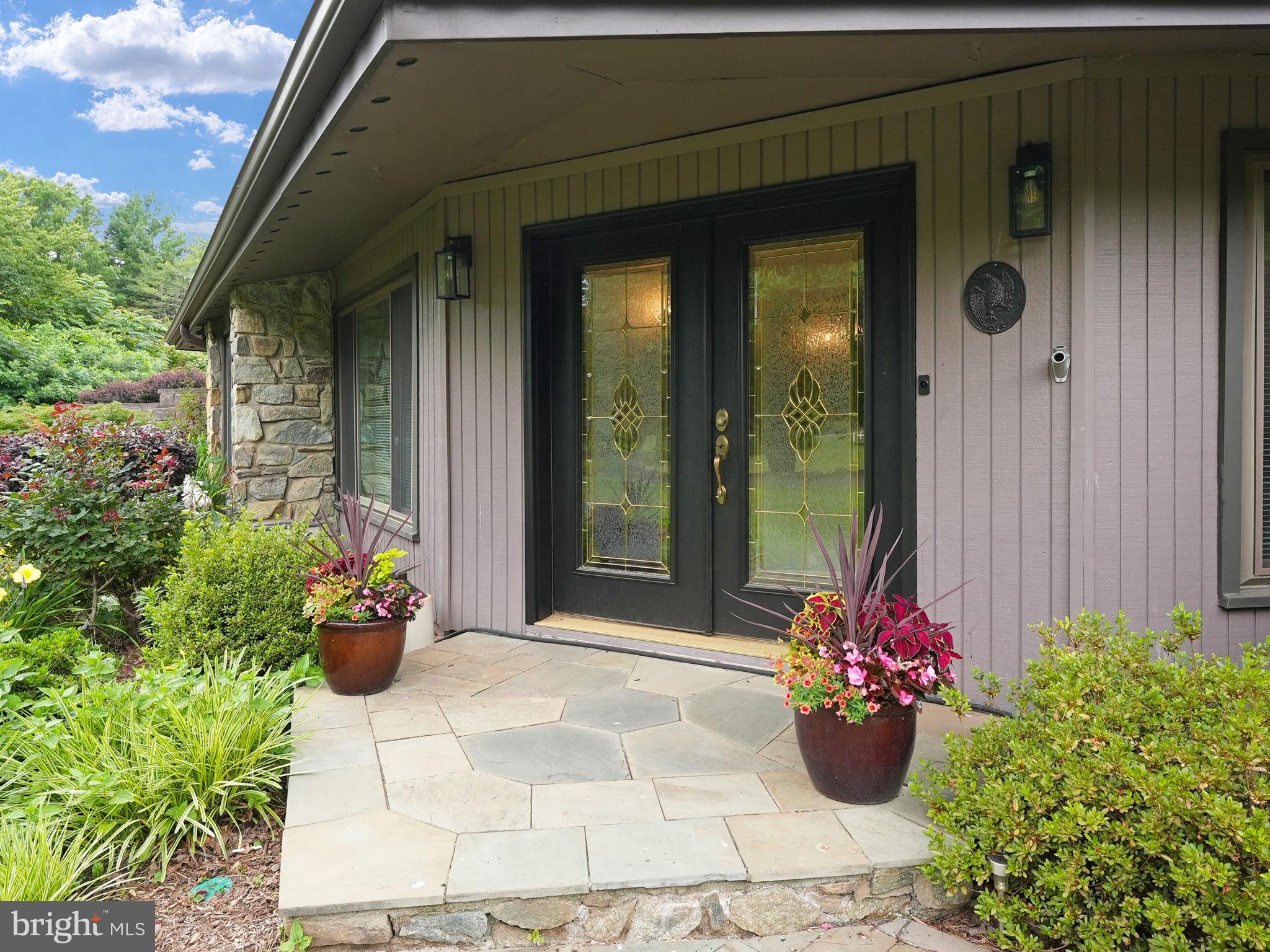 Inviting Double Front Door Entry Opens to Foyer.