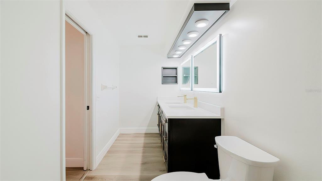 4225 La Pasida Lane New Port Richey, FL 34655 - Photo 27 of 55 a bathroom with a sink toilet and mirror