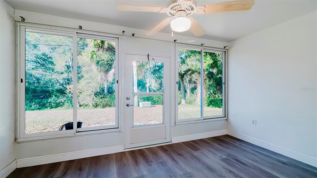 4225 La Pasida Lane New Port Richey, FL 34655 - Photo 50 of 55 a view of an entryway with wooden floor and garden view