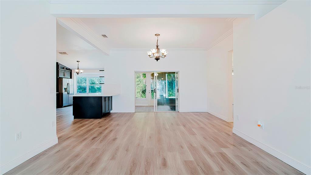 4225 La Pasida Lane New Port Richey, FL 34655 - Photo 6 of 55 a view of a room with wooden floor potted plant and windows