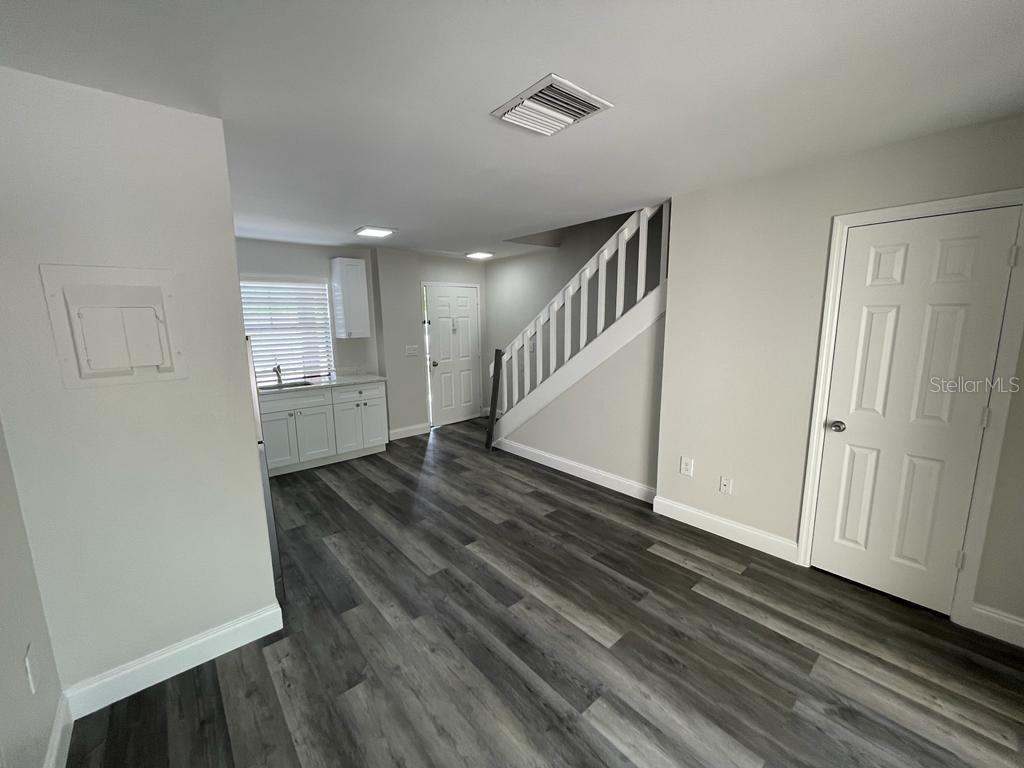 10260 Turkey Lake Road, Unit 150 (A30) Orlando, FL 32819 - Photo 3 of 13 a view of entryway and hall with wooden floor