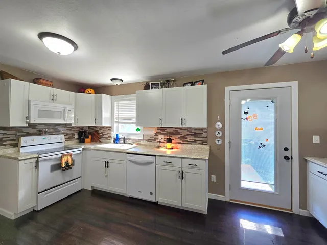 a kitchen with stainless steel appliances granite countertop a sink and cabinets