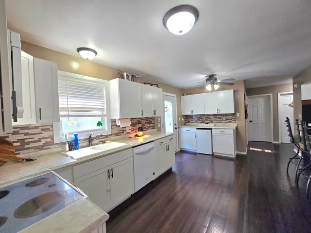 a kitchen with a sink window and cabinets
