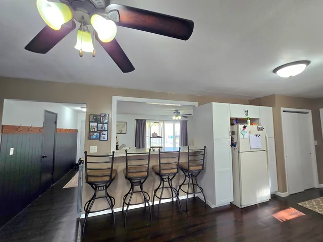 a dining room with furniture and wooden floor