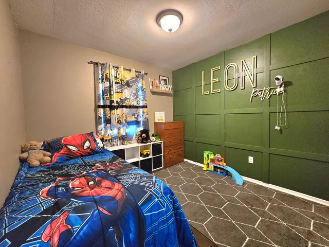 a room with gym equipment and a chandelier