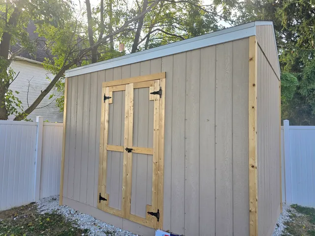 a view of a wooden door in front of house