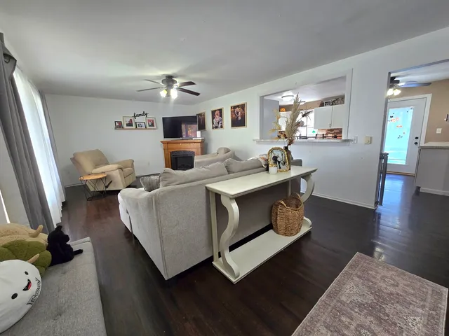 a living room with furniture and a wooden floor