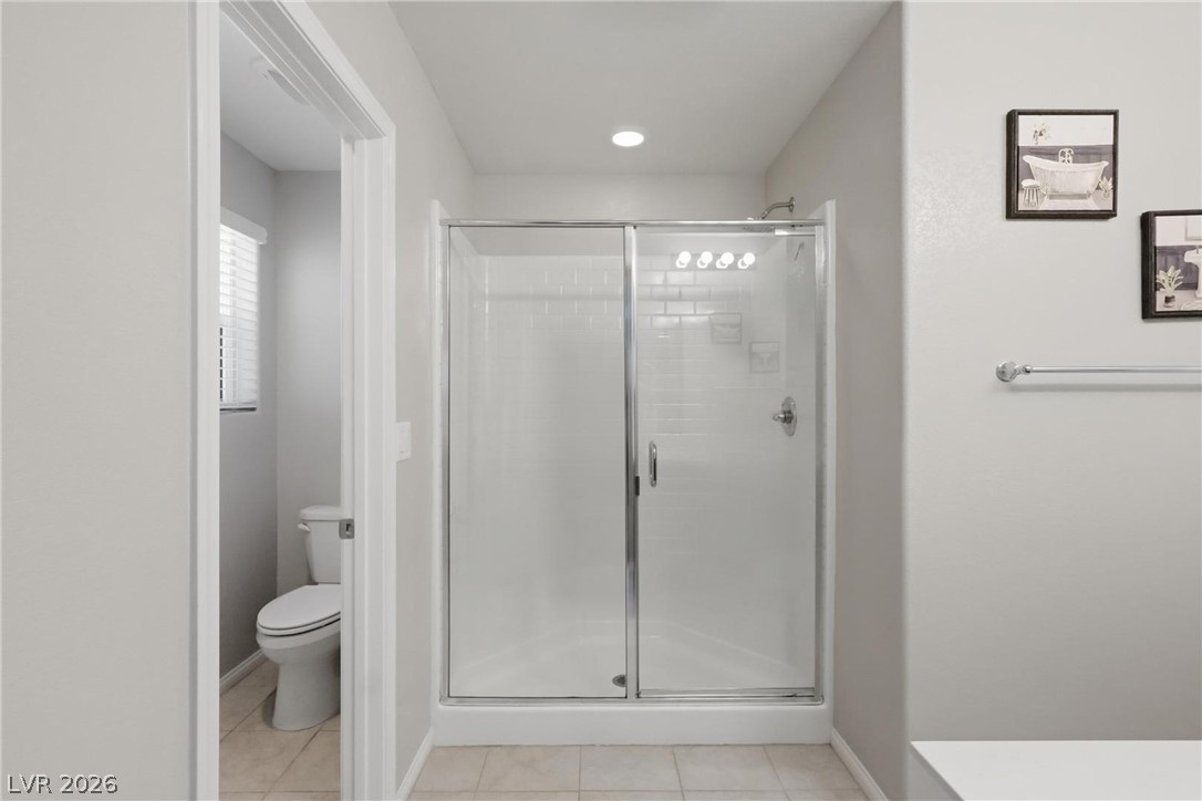 1921 Miller Ridge Avenue North Las Vegas, NV 89031 - Photo 19 of 26 This modern bathroom features a sleek glass-enclosed shower, perfect for daily routines.