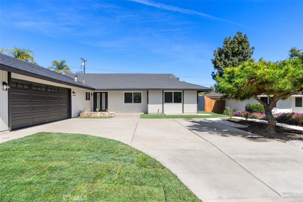 5417 Peacock Lane Riverside, CA 92505 - Photo 11 of 44 a front view of a house with a yard and garage