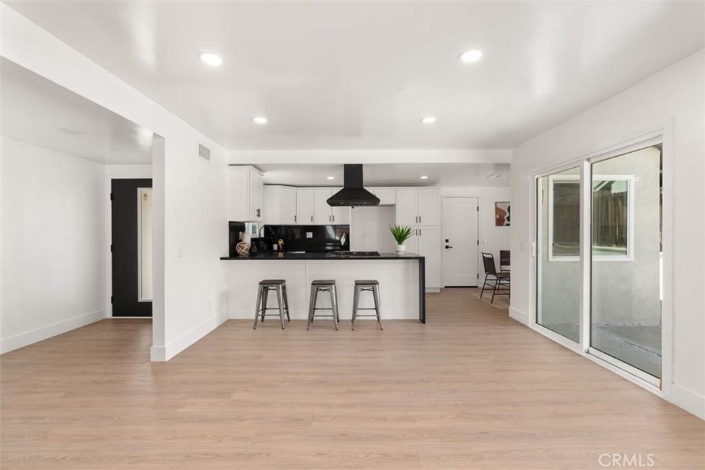 5417 Peacock Lane Riverside, CA 92505 - Photo 18 of 44 a kitchen with stainless steel appliances kitchen island granite countertop a refrigerator and a stove top oven