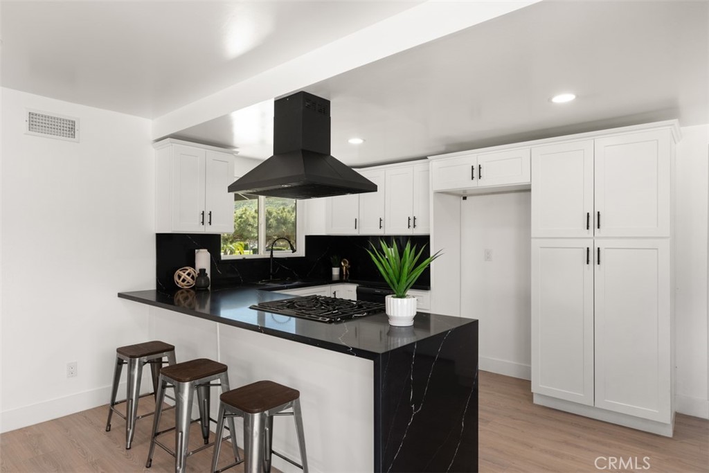 5417 Peacock Lane Riverside, CA 92505 - Photo 21 of 44 a kitchen with stainless steel appliances a counter space a sink and a refrigerator