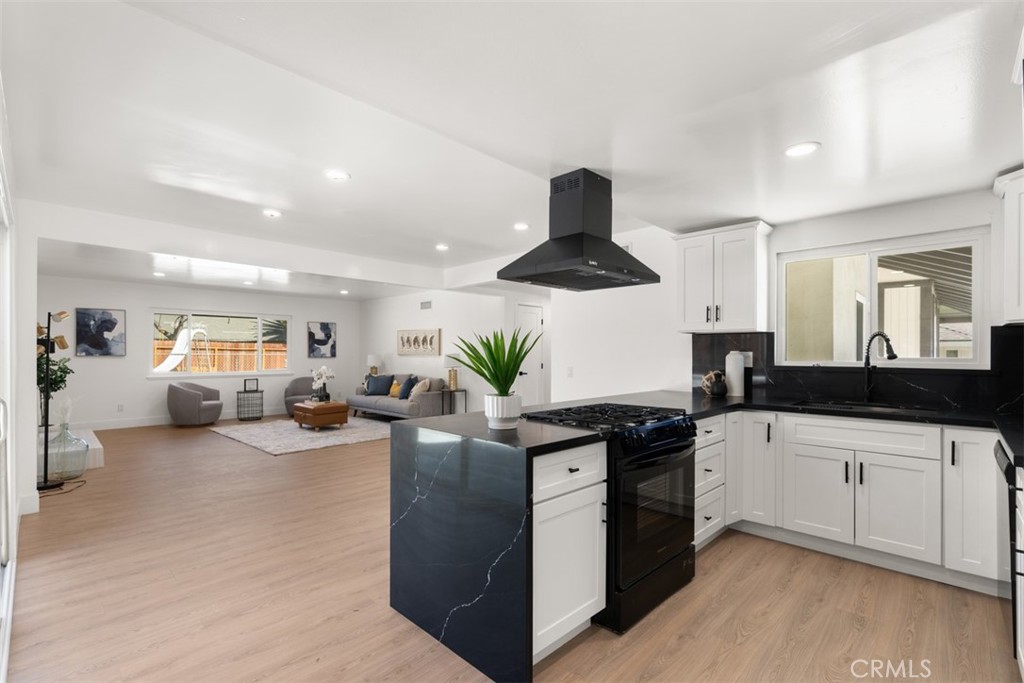 5417 Peacock Lane Riverside, CA 92505 - Photo 22 of 44 a kitchen with granite countertop a sink and a stove top oven