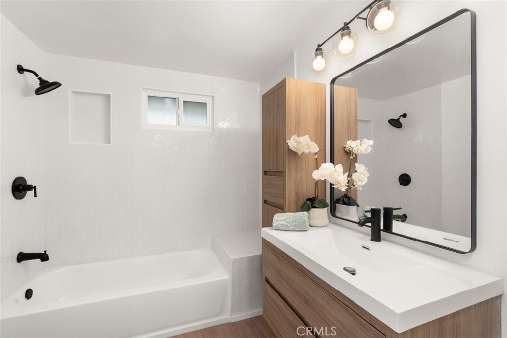 5417 Peacock Lane Riverside, CA 92505 - Photo 25 of 44 a bathroom with a sink a mirror and a bathtub