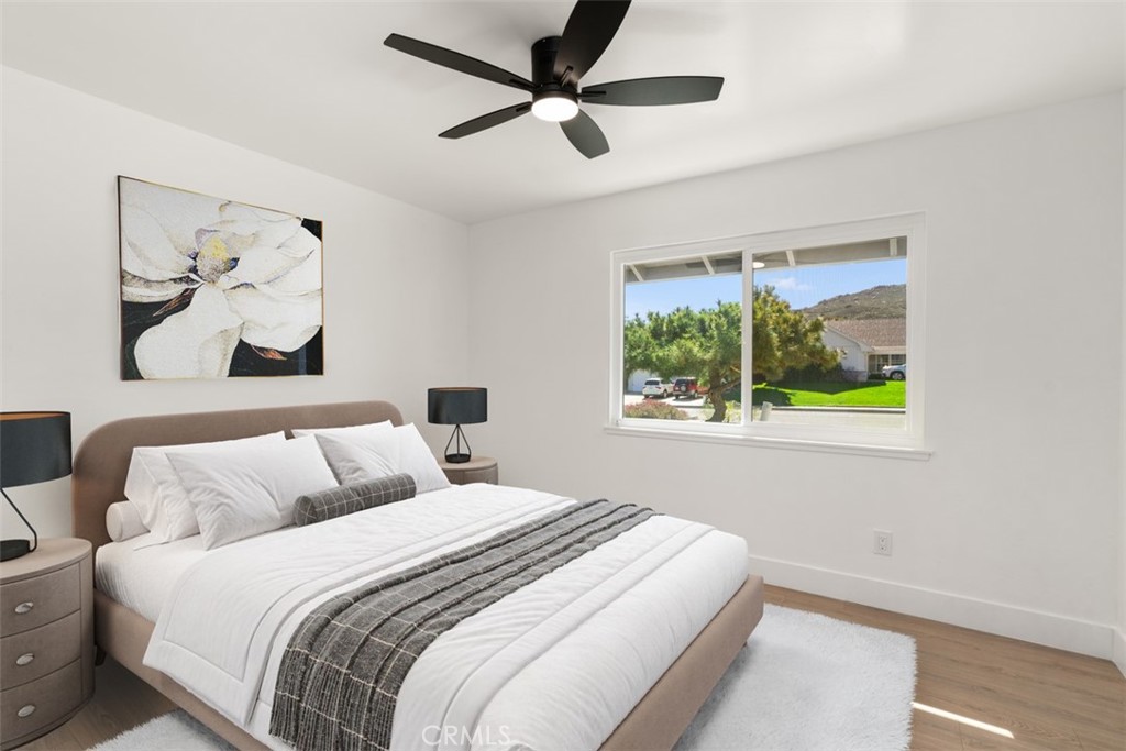 5417 Peacock Lane Riverside, CA 92505 - Photo 31 of 44 a bedroom with a bed and a painting on the wall