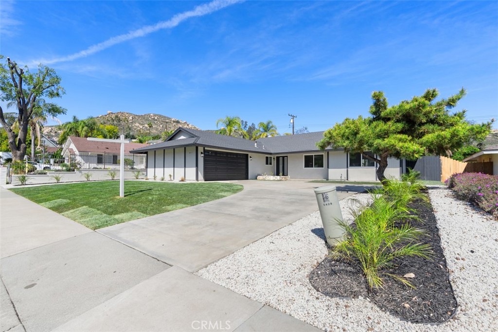 5417 Peacock Lane Riverside, CA 92505 - Photo 9 of 44 a front view of a house with a yard and potted plants