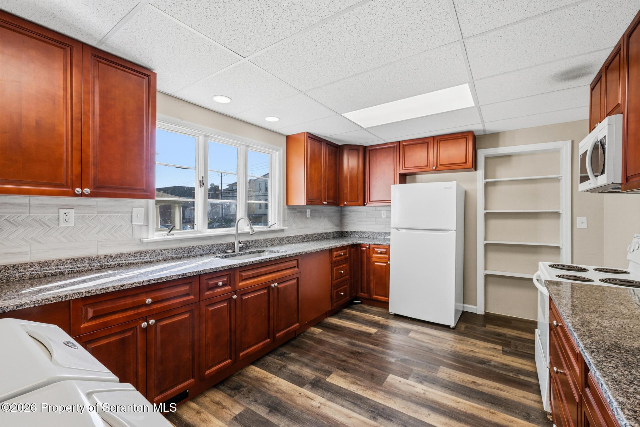 801 Adams Avenue Scranton, PA 18510 - Photo 12 of 34 a kitchen with stainless steel appliances granite countertop a refrigerator and a sink