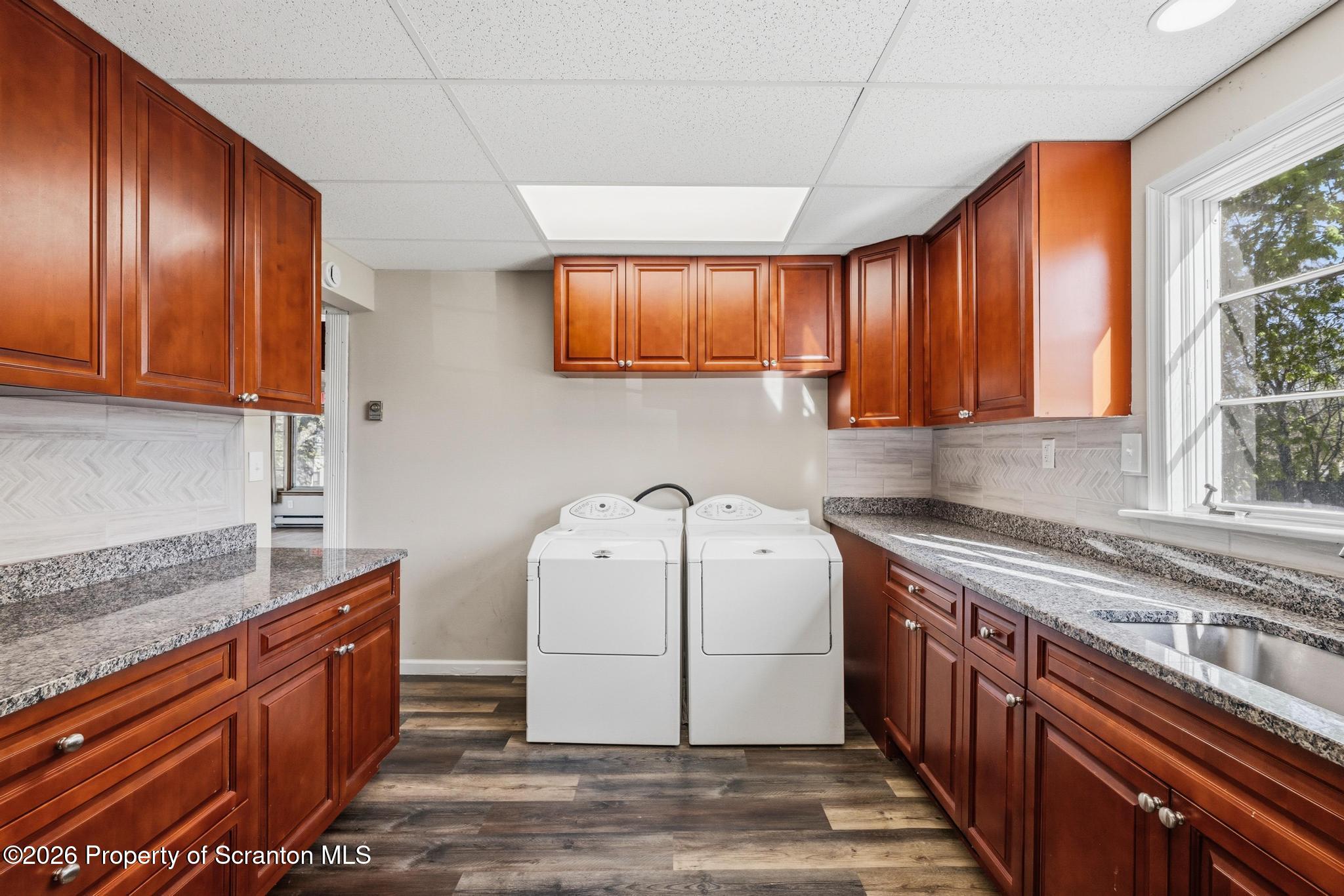 801 Adams Avenue Scranton, PA 18510 - Photo 14 of 34 a kitchen with wooden cabinets and white appliances