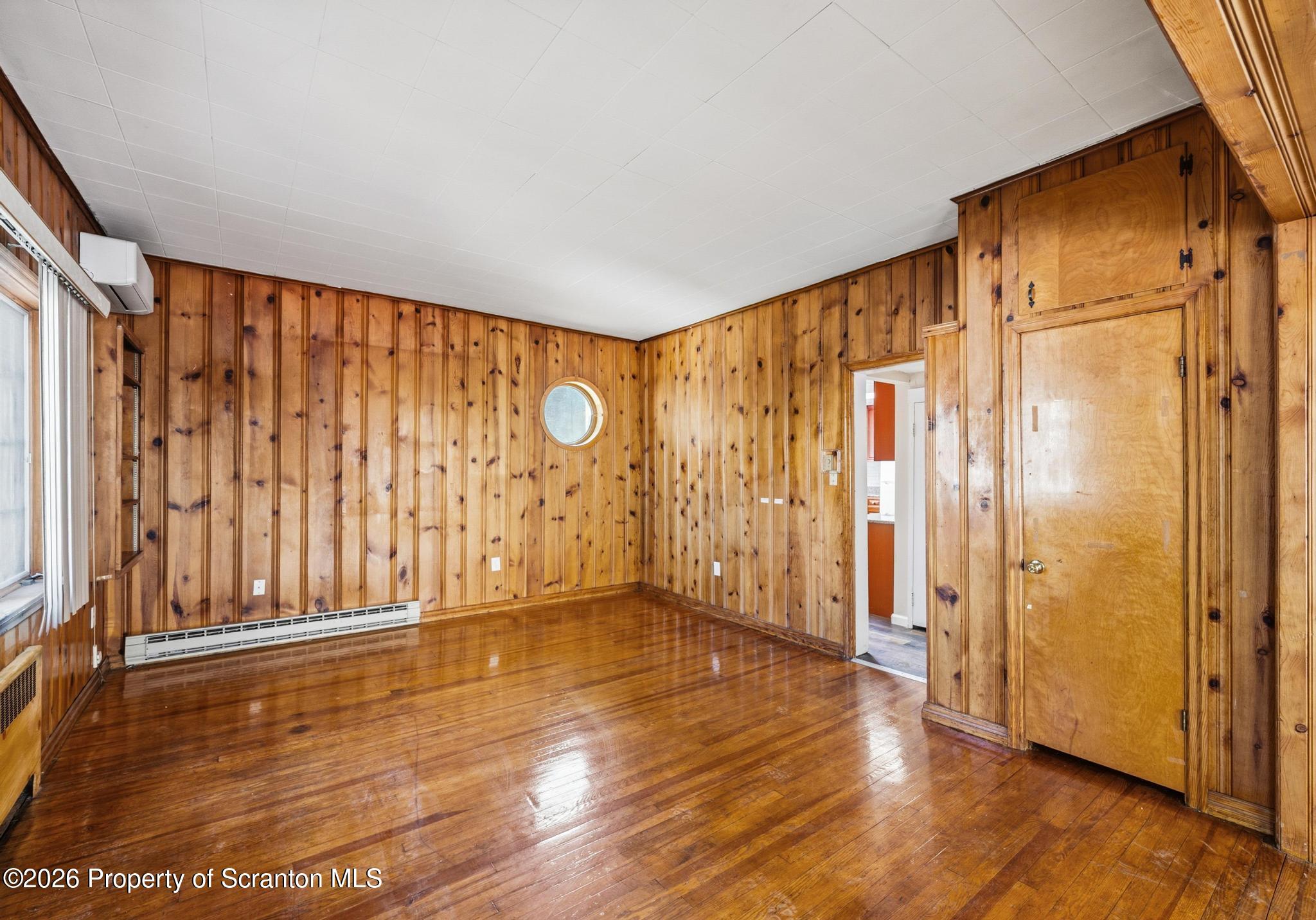 801 Adams Avenue Scranton, PA 18510 - Photo 15 of 34 a view of an empty room with wooden floor and a window