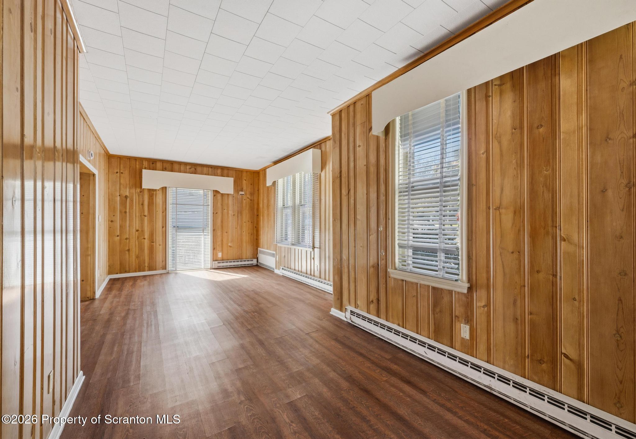 801 Adams Avenue Scranton, PA 18510 - Photo 17 of 34 an empty room with wooden floor and windows