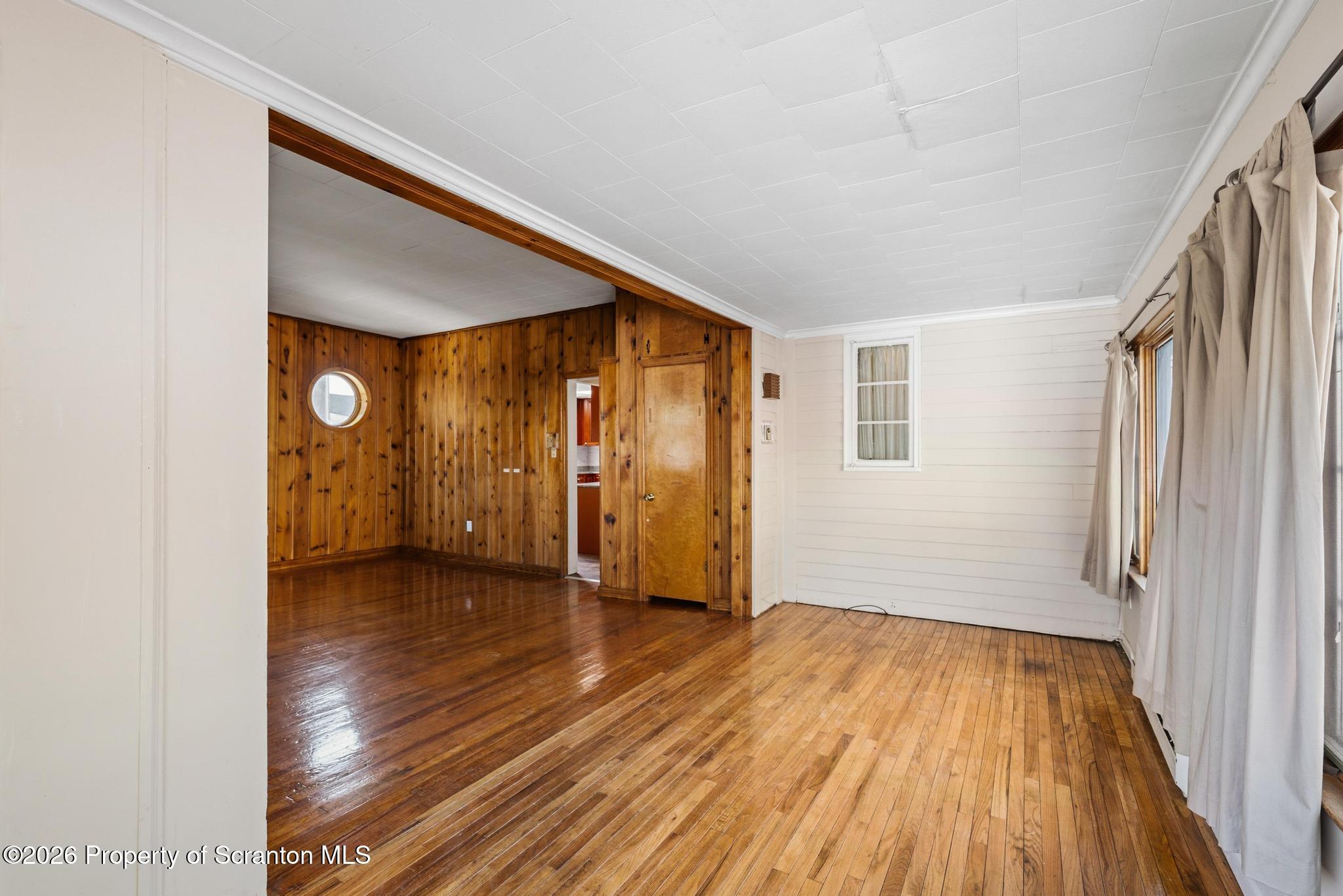 801 Adams Avenue Scranton, PA 18510 - Photo 20 of 34 a view of an empty room with wooden floor and a window