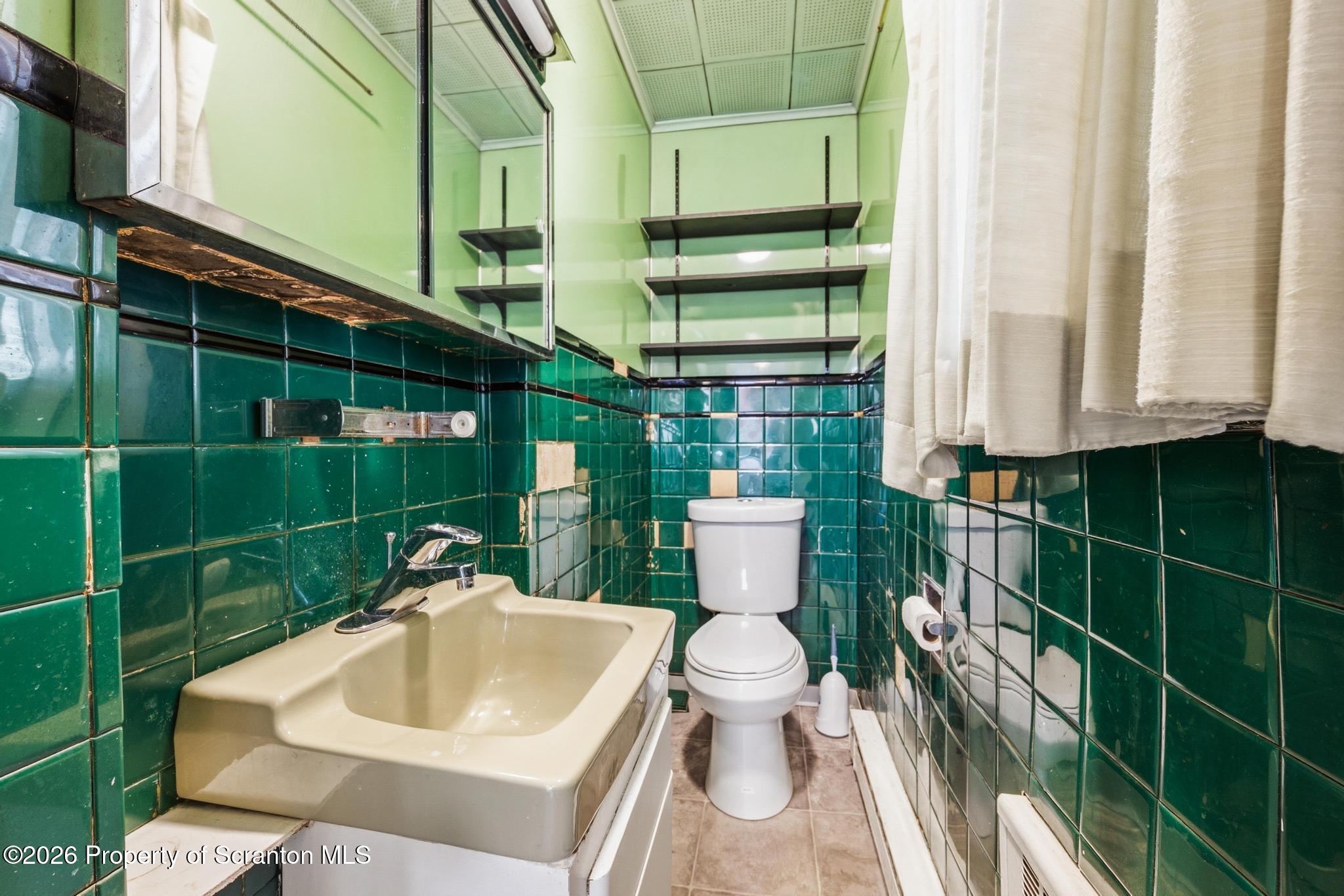 801 Adams Avenue Scranton, PA 18510 - Photo 21 of 34 a white toilet sitting next to a bathroom sink