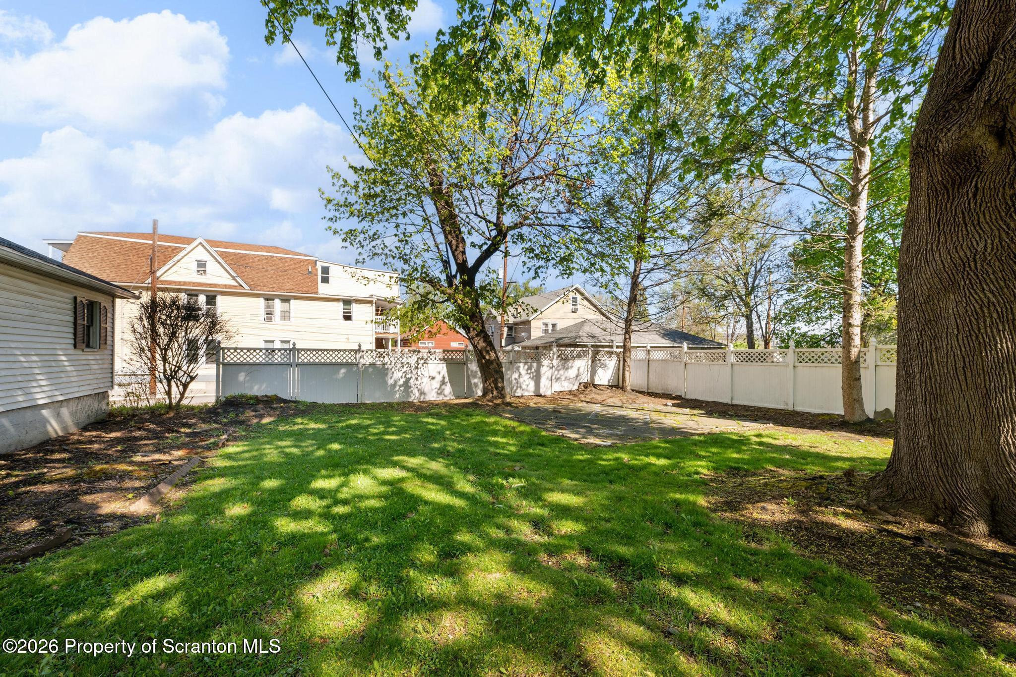 801 Adams Avenue Scranton, PA 18510 - Photo 32 of 34 a view of a yard with a house in the background