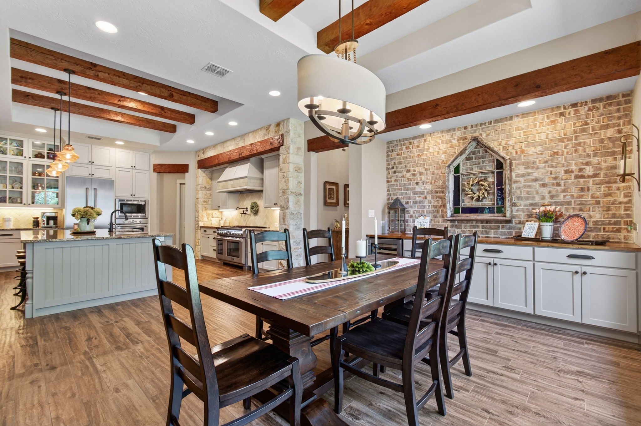 715 Long Ridge Spring Branch, TX 78070 - Photo 7 of 40 Rich ceiling beams and brick accents highlight this open concept dining space.