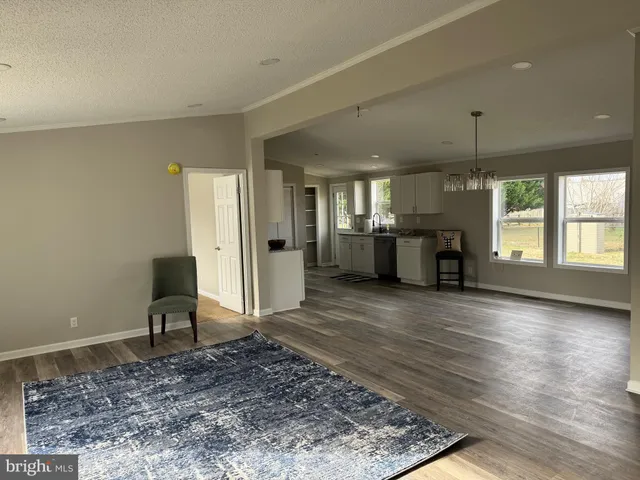 a view of a bedroom with furniture and windows