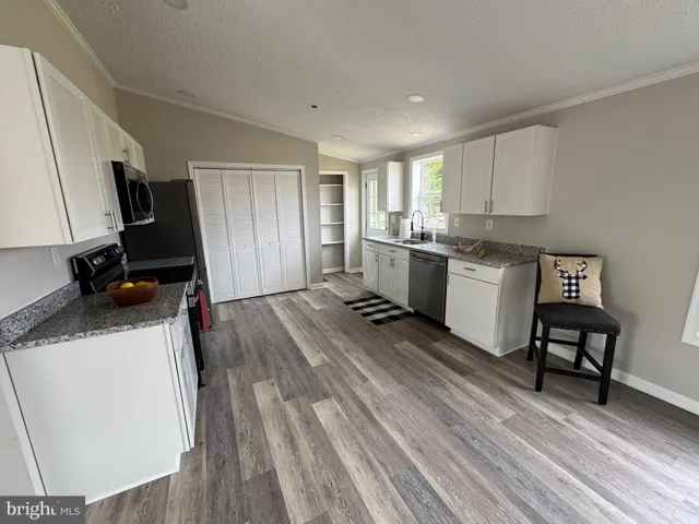 a kitchen with sink cabinets and window