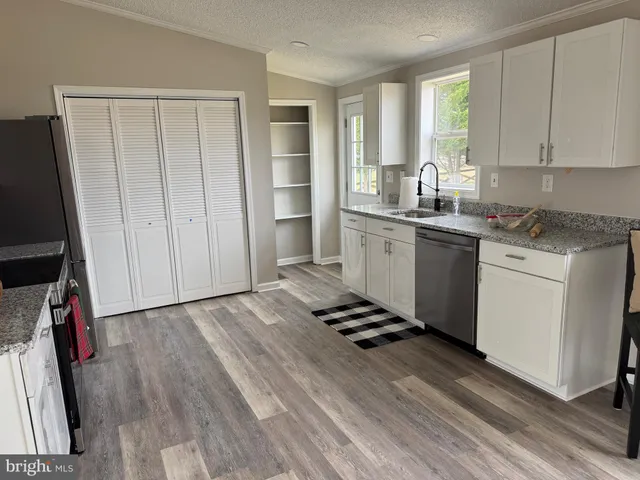 a bed sitting in a room next to a window