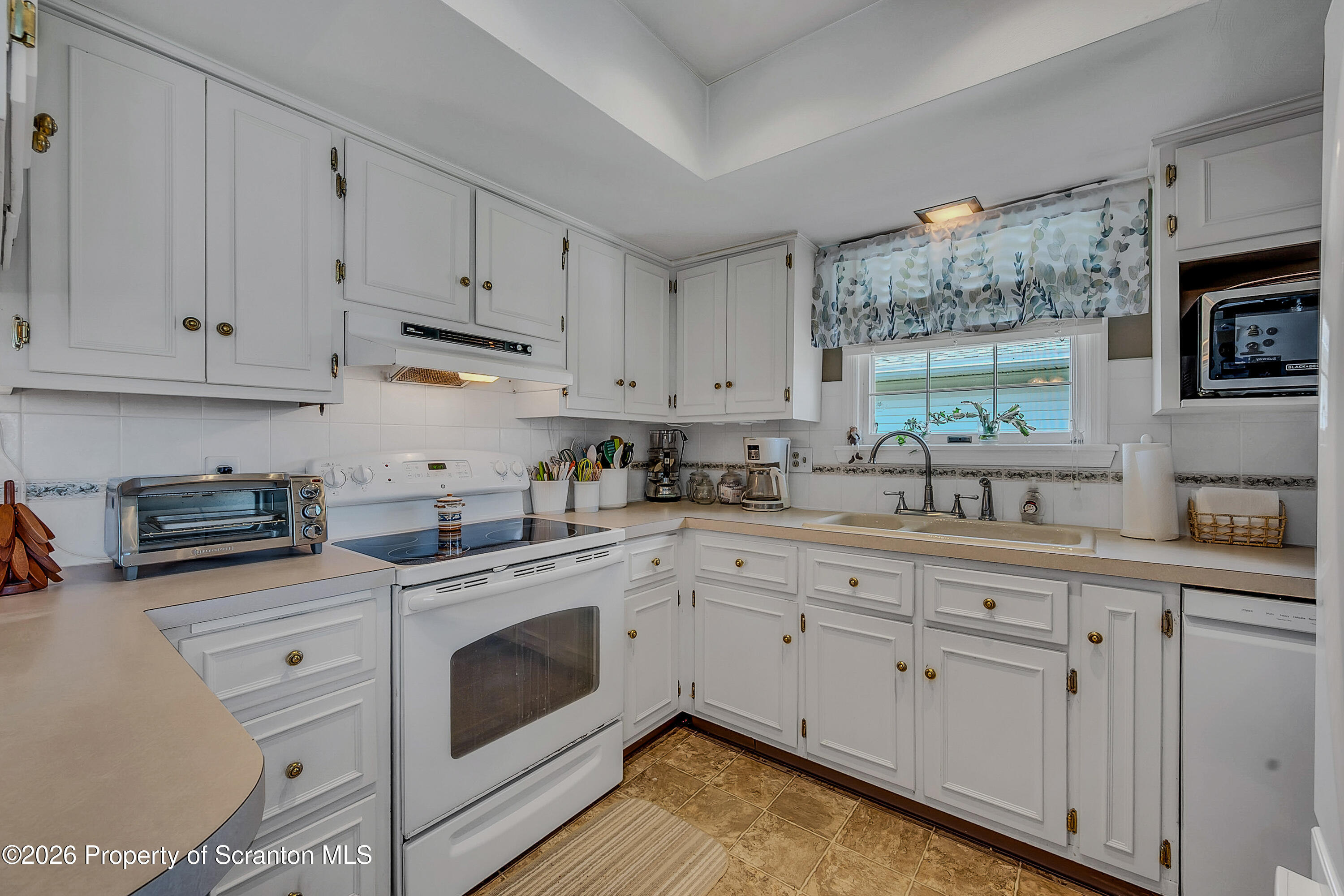 1832 West Gibson Street Scranton, PA 18504 - Photo 11 of 54 a kitchen with cabinets stainless steel appliances a sink and a window
