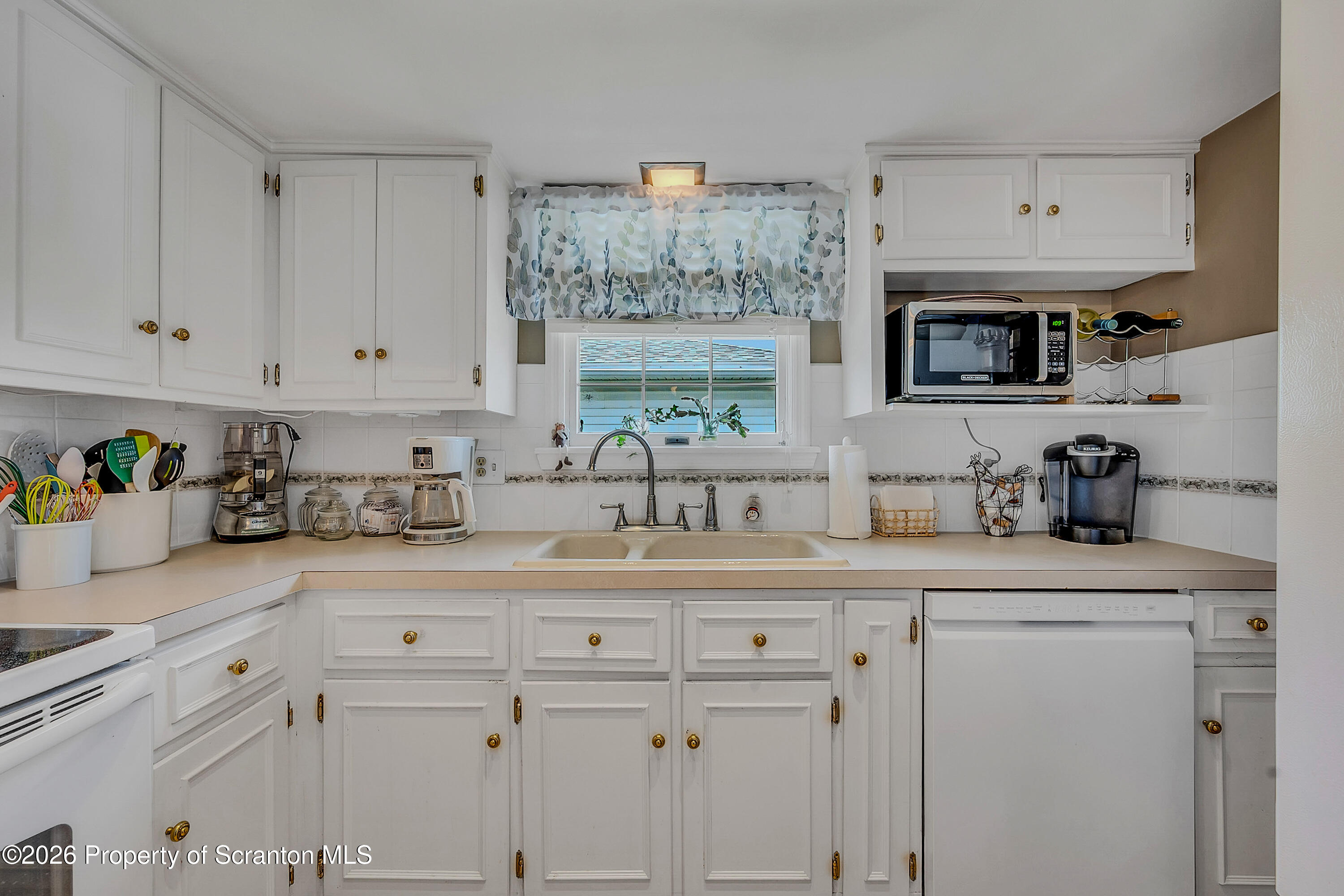 1832 West Gibson Street Scranton, PA 18504 - Photo 10 of 54 a kitchen with white cabinets and white appliances