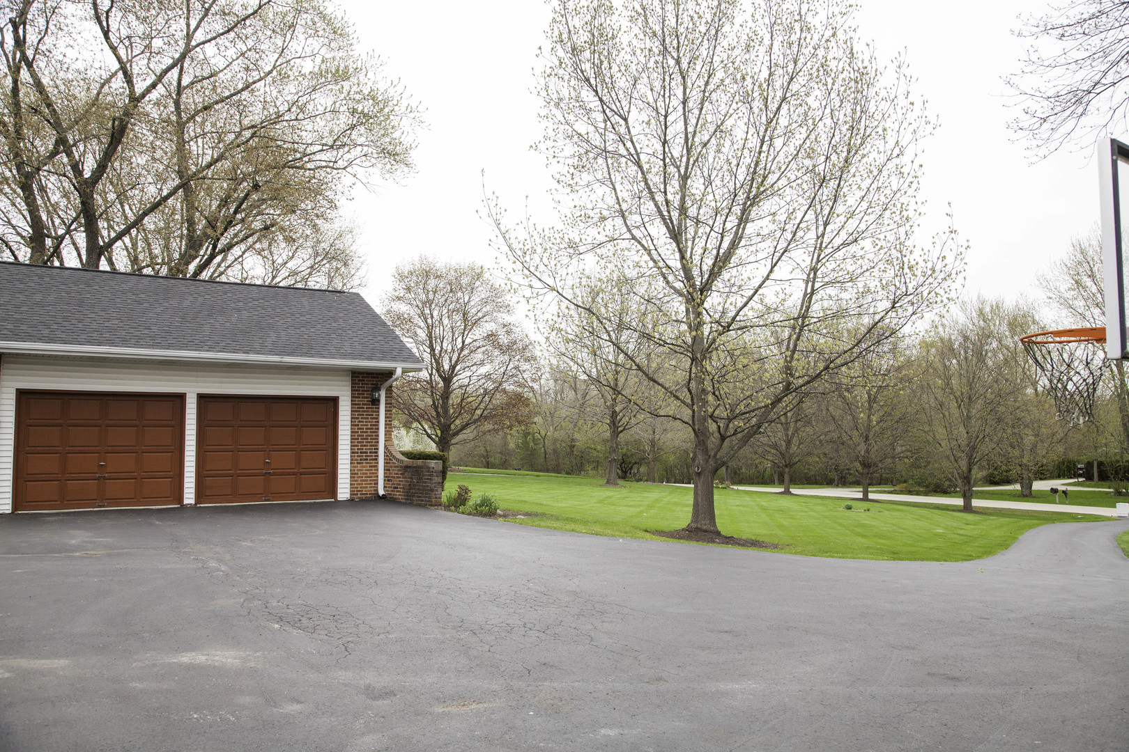 1630 Dunbar Road Inverness, IL 60067 - Photo 6 of 8 a view of a house with a yard and garage