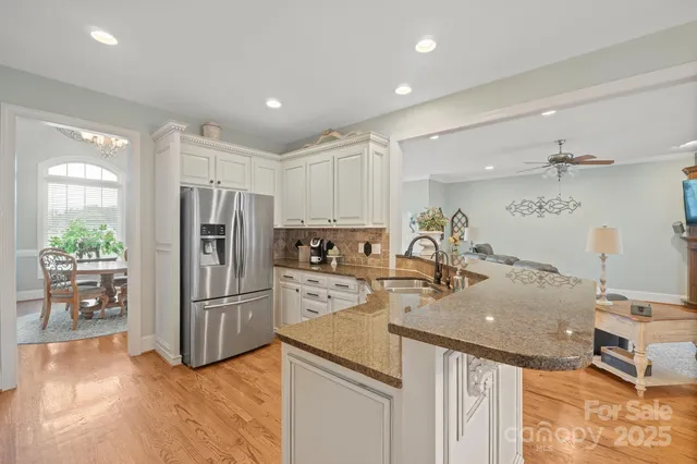 a kitchen with stainless steel appliances granite countertop a stove microwave and cabinets