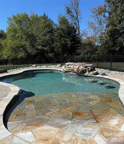 a view of a swimming pool with a yard