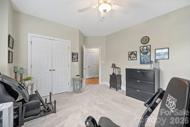 a bathroom with a granite countertop sink mirror and toilet