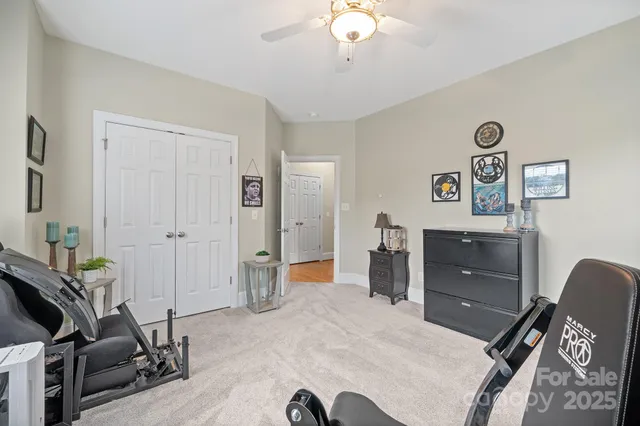 a spacious bedroom with a bed and a chandelier