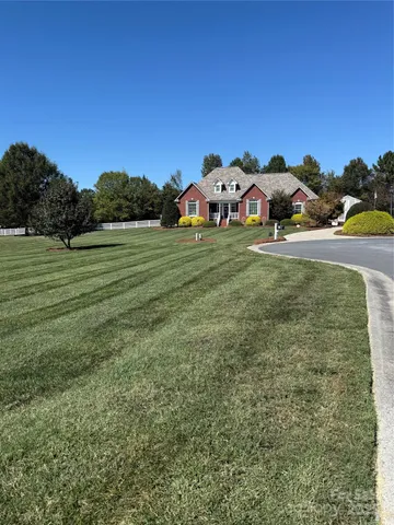 a view of a big yard with table and chairs